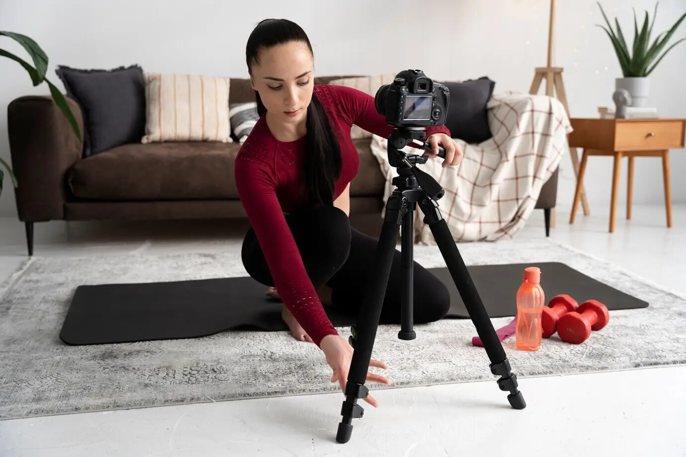 An online sport fitness instructor filming her session.