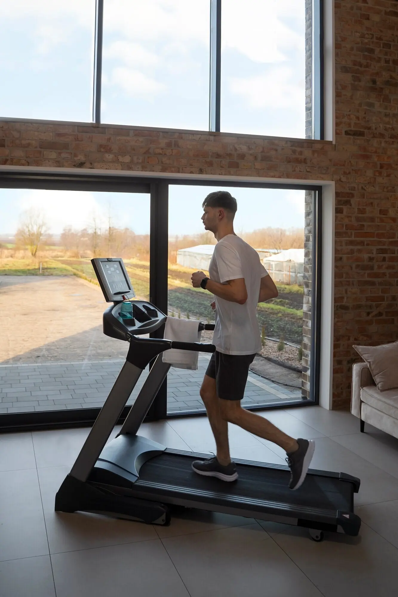 A young adult working out at home.